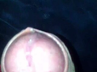 In the quiet room, a man indulges in solo pleasure with his cock, stroking rhythmically to build intense sensations.