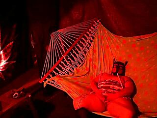 getting frisky in a tent, fingering her wet hole in a hammock