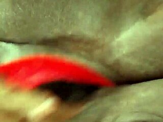 Ebony milf playing with dildo in lingerie, shaved pussy on display