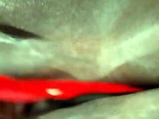 Ebony milf playing with dildo in lingerie, shaved pussy on display