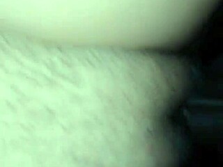 in the dimly lit room, a massive black cock slides deep into her tight pussy, stretching her wide