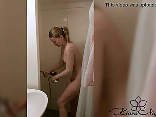 blonde teen soaps up, fingers herself in steamy shower fun.
