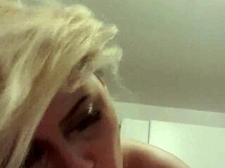 The wife is giving a great blowjob on webcam, her blonde hair bouncing as she sucks her husband's wet cock.
