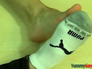 gay kinky hunk gives footjob and cums on feet