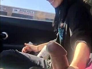 Wow! Lesbian strokes friend’s huge black cock in a wild car handjob session!