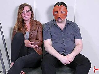 a bound participant receives a facial in a fetish scene