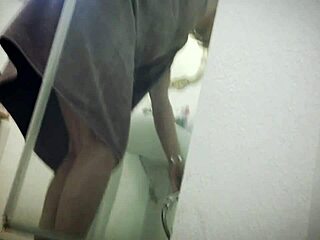 Blonde girlfriend surprised from behind in bathroom