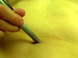 Fifi Foxx engages in detailed belly button play while topless