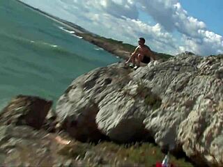 Fiery redhead receives intense facial cumshot on outdoor rocks