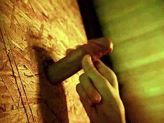 Twink performs blowjob through glory hole