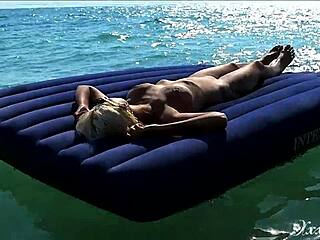 Look at this hot blonde with big boobs going nude on a public beach