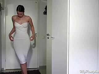 Girl in bra and pantyhose poses.