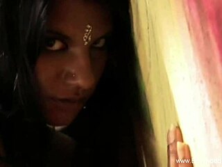 Sexy brunette strips naked by the warm fire