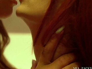 Brunette and redhead kissing in photo shoot