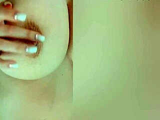 Busty beauty teases big nipples on camera while parents sleep