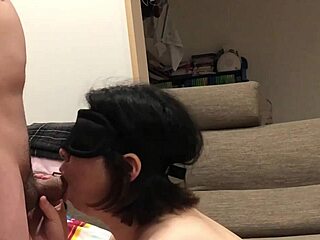 Japanese couple enjoys blowjob and raw sex on sofa.