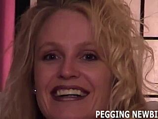 She opens her cheeks, ready for the strapon in this femdom scene.