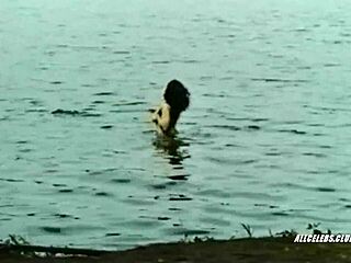 Kathleen Beller topless in Surfacing 1981, revealing retro nude charm. What hidden desires surface in this classic scene?