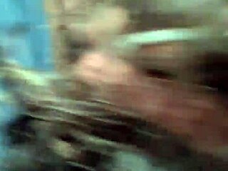 Amateur gay guys give head in a car on a rainy day outdoors.