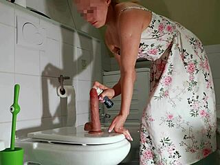 Hot redhead milf sneaks into toilet to bang a big dildo hard
