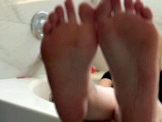 Blonde babe oiled up shows off her fetish feet in detail
