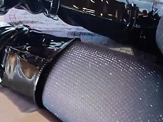 Sexy Brunette In Latex And Fishnets Teases With Pantyhose And Over-The-Knee Boots