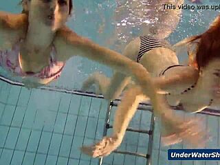 horny girls strip each other in the pool, getting wild underwater