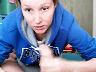 brunette in hoodie sucking cock passionately