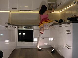 Redhead Cheerleader Shows Panties In Kitchen