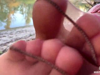 My cute feet in nude tights rub against each other on the autumn river bank
