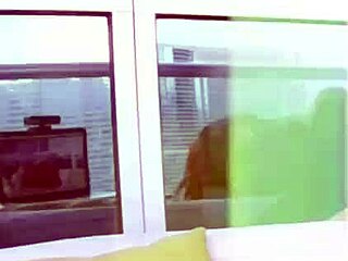 Busty redhead public balcony tease.