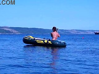 mature babe lounges in bikini on volga river boat ride