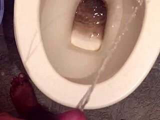 she squats low letting her monster cock drip cum while peeing nice and steady