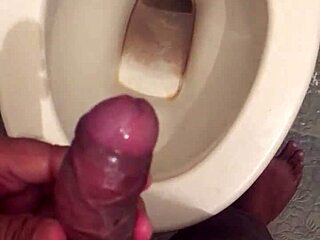 she squats low letting her monster cock drip cum while peeing nice and steady