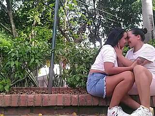 Two horny lesbians masturbate their pussies in a public park