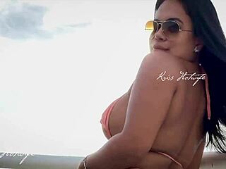 This married brunette is showing off her huge ass in the rooftop pool