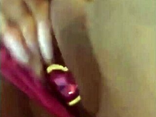 She indulges in a steamy solo session with her dildo on her cozy bed.
