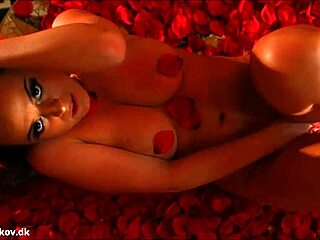 Do you see how Denise Klarskov plays with her wet pussy in a sea of red roses?