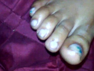 Ebony beauty delivers a teasing footjob leading to cumshot