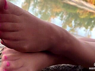 My cute feet in nude tights rub against each other on the autumn river bank