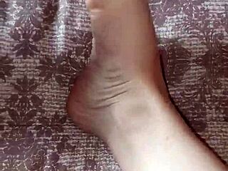 Gretala casually rubs her thong on her bare feet