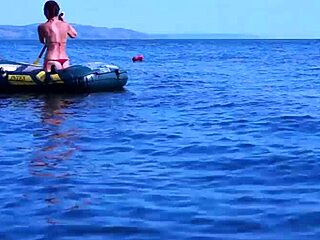 mature babe lounges in bikini on volga river boat ride