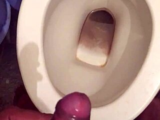 she squats low letting her monster cock drip cum while peeing nice and steady