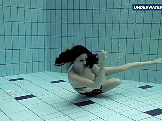 brunette flashes big tits underwater at beach pool making onlookers horny